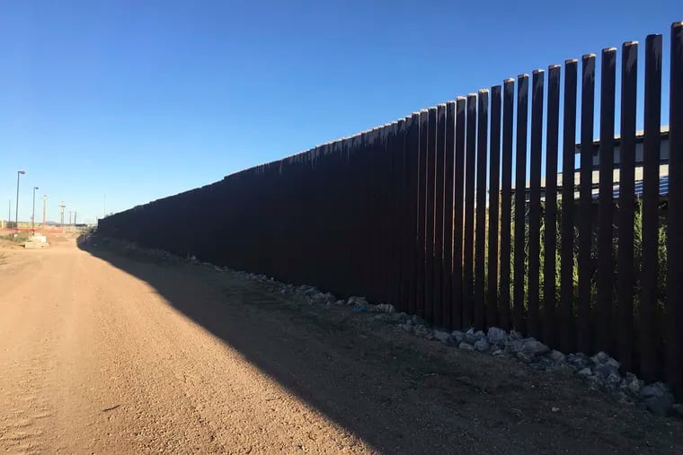FILE - In this Oct. 3, 2018, file photo, a border fence in Columbus, N.M., sits along the U.S.-Mexico border at sunset. Residents of this tiny, historic border village are raising concerns about new trailers in the town center meant to house workers building the U.S.-Mexico border wall despite worries over COVID-19. (AP Photo/Russell Contreras, File)