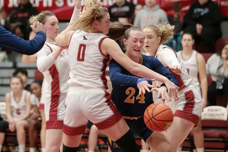 La Salle’s Amy Jacobs (24) battles through St. Joe's players for a rebound in the second half.