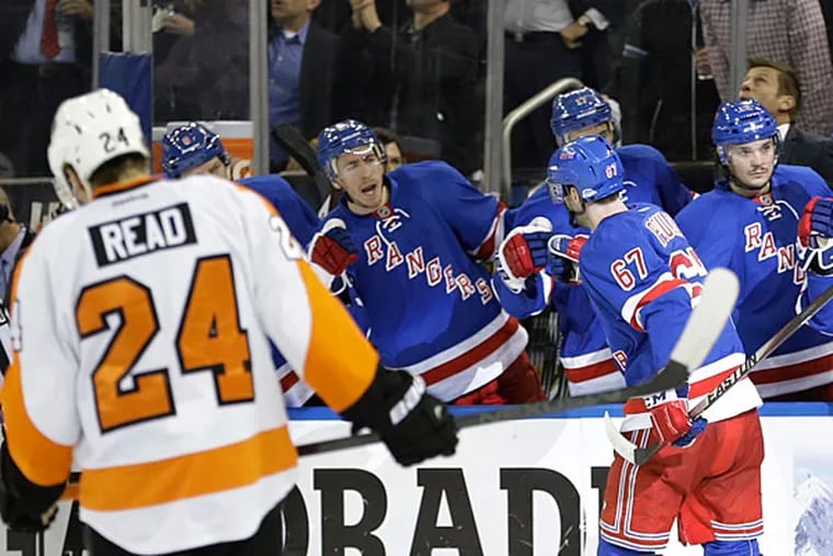 Matt Read (24) skates away as New York Rangers' Benoit Pouliot (67) celebrates with teammates after scoring a goal during the second period in Game 7 of an NHL hockey first-round playoff series on Wednesday, April 30, 2014, in New York. (AP Photo)