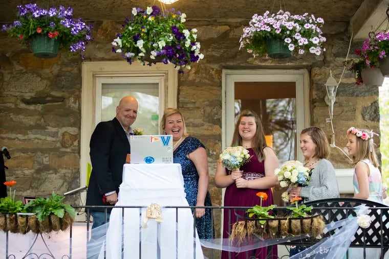 Joy Karsner, 39, and her fiance, Brian Barton, 44, of Springfield in Delaware County eloped on their front lawn on April 24, 2020 . The officiant is Zooming in from Rochester, 300 guests are attending Facebook, and their neighbors plan to dress up and stand in their driveways.  Joy's three daughters will participate in the ceremony. Her eldest, Alison, 14, center, will be the maid of honor. Her youngest, Eva, rightt, 9, will be the flower girl, and her middle daughter, Katelyn,  2nd from right, 11, will be “starring as herself" per her request. Drager is the last name of the girls.