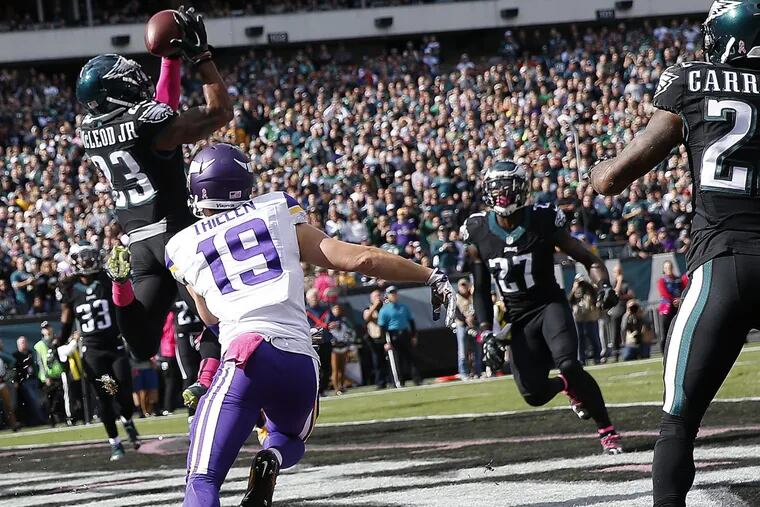Eagles’ Rodney McLeod (left) intercepts a pass in the end zone intended for the Vikings’ Adam Thielen (center) during the first quarter of an Oct. 23, 2016, game at Lincoln Financial Field.