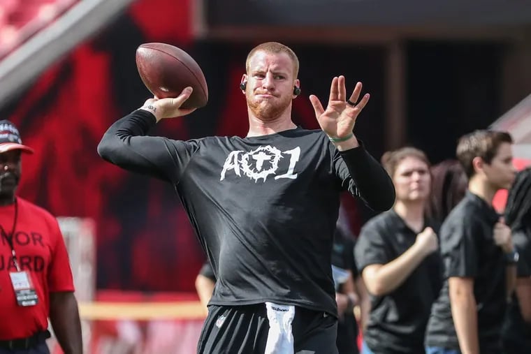 Carson Wentz warms up on the field at Raymond James Stadium on Sunday prior to the Eagles' loss to the Buccaneers.