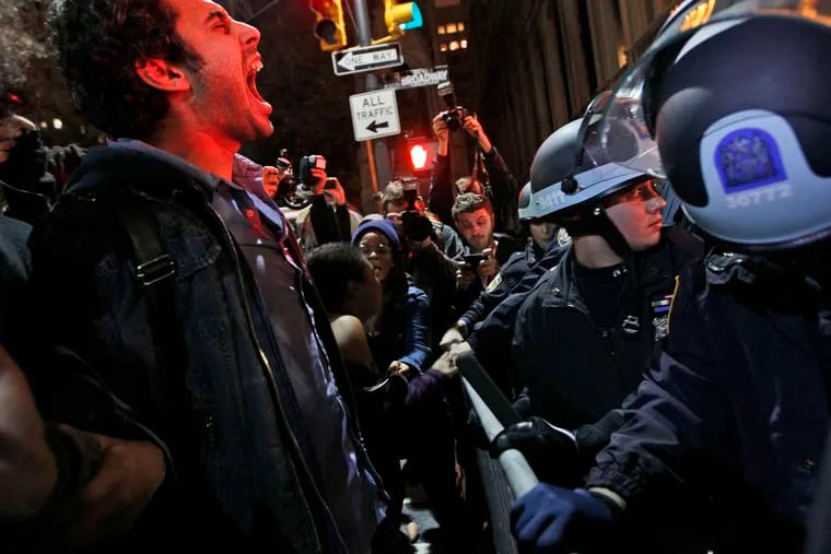An Occupy Wall Street protester yells at police after being ordered to leave Zuccotti Park, the group's encampment in New York, in 2011.