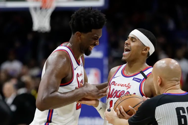Sixers center Joel Embiid and forward Tobias Harris celebrate at the end of overtime.