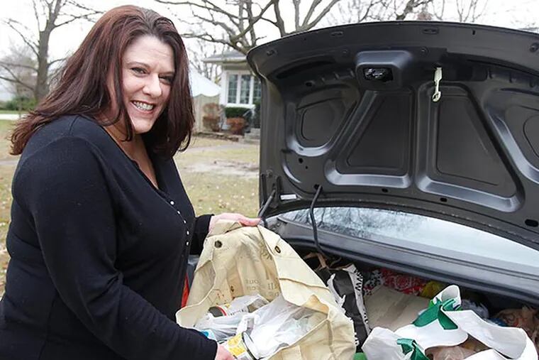 Kathy Denz is showing bagful of collected foods in her trunk of a car parked her mother’s home in Magnolia, NJ on November 23, 2013. For 14 years, Bellmawr resident Kathy Denz has taken it upon herself to collect food for the Food Bank of SJ. She has volunteers, including her mother, but mostly runs the whole thing out of the trunk of her car. (AKIRA SUWA  /  Staff Photographer)
