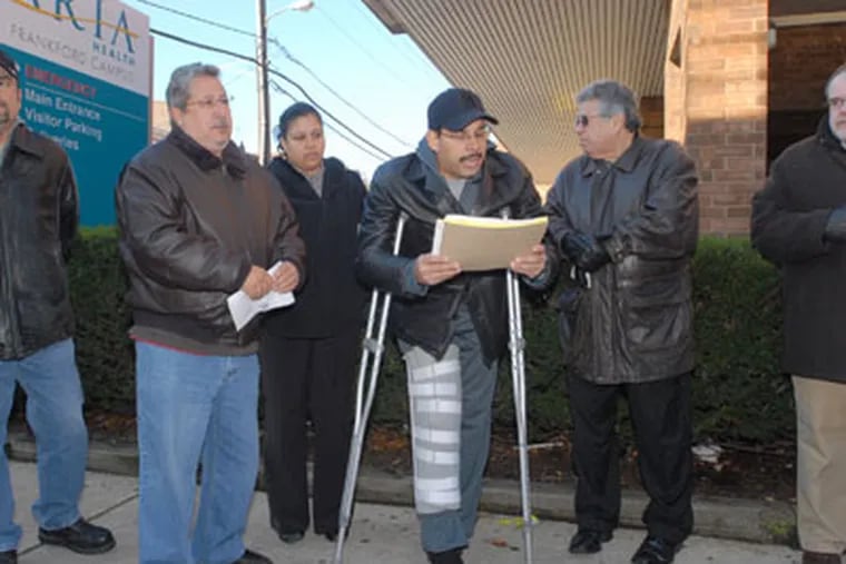 Victor Vazquez, president of the National Congress For Puerto Rican Rights (left), stands by as Pa. Chapter President Joe Garcia speaks to the media. (Bob Williams /For the Inquirer)