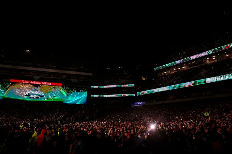 Some of the over 70,000 attendees record the final match during WrestleMania 40 at Lincoln Financial Field.
