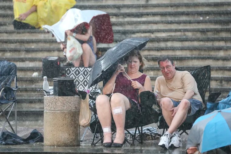 People braved stormy weather before a free outdoor concert at Penn's Landing on Friday, June 28, 2019. More storms passed through the region on Saturday, causing power outages and knocking down trees.