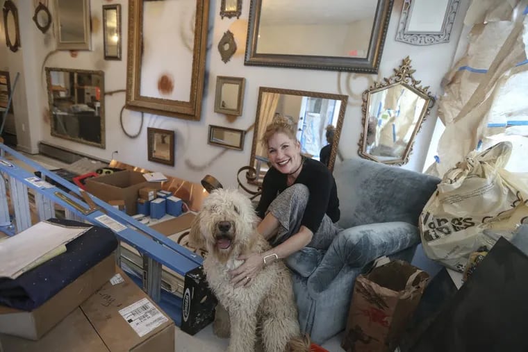 Singer-songwriter Laura Mann, disappointed with the lack of rock spaces in the city for small acts and women, decided to open her own space — the Living Room in Ardmore. Mann and her dog, Casey, in the final stages getting ready for the opening.