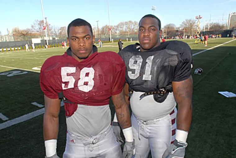 Temple's Joseph twins, Elijah (left), linebacker, and Elisha, nose tackle, will both be starting for the Owls this fall. (April Saul / Staff Photographer)