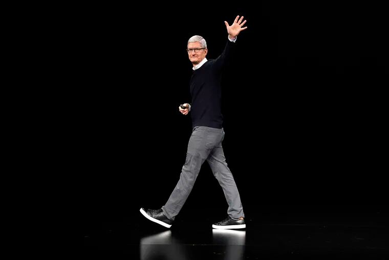 FILE - Apple CEO Tim Cook waves while walking off stage at the Steve Jobs Theater after an event to announce new products Monday, March 25, 2019, in Cupertino, Calif.