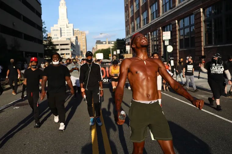 Nasir Bell of the activist group I Will Breathe leads a chant during a protest in support of Black Lives Matter and against the Trump administration’s deployment of federal officers to U.S. cities along Callowhill Street in Philadelphia on Saturday, July 25, 2020. Federal officers have repeatedly fired tear gas and other munitions at protesters in Portland, prompting concern from local residents and officials over the possibility of their deployment to Philadelphia.