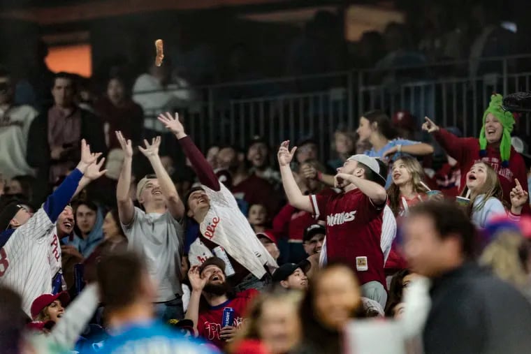 Phillies fans throw hot dogs in the eighth inning against the Marlins during a Dollar Dog Night in April 2023.