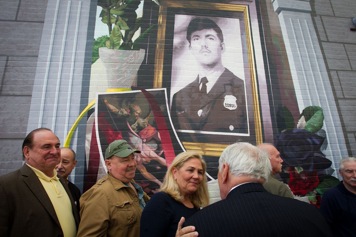 Maureen Faulker, widow of Daniel Faulkner, greets friends, colleagues of her husband, and supporters at a mural dedication. The Philadelphia Police Department, Fraternal Order of Police, and Philadelphia Mural Arts Program unveiled a mural dedicated to fallen Officer Daniel Faulker on Nov. 24, 2014.