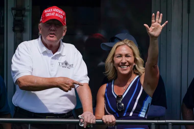 Rep. Marjorie Taylor Greene (R., Ga.) and former President Donald Trump at the Bedminster Invitational LIV Golf tournament in Bedminster, N.J., in July 2022.