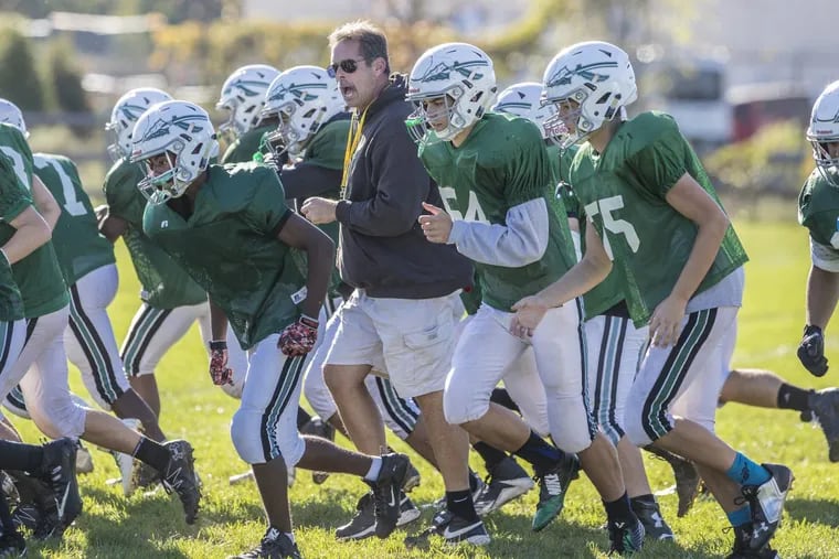 Methacton head coach coach Paul Lepre, center, runs sprints with his players in October.
