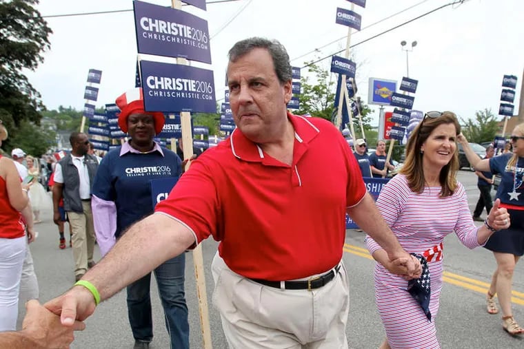 Gov. Christie shakes a hand as he walks in a Fourth of July parade with his wife, Mary Pat, in Wolfeboro, N.H. On Friday, Mitt Romney was host at his summer home there to Christie and Sen. Marco Rubio.