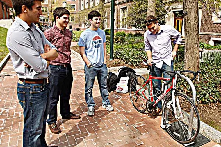 Penn Engineer students Joseph Polin (from left), Alex Neier, Justin Starr, and Joseph Hill demonstrate the PubLock. They designed a public bike rack with built-in locking system, usable by anyone with a personalized electronic RFID code. (Monday, April 28, 2014 / RON CORTES / Staff Photographer).