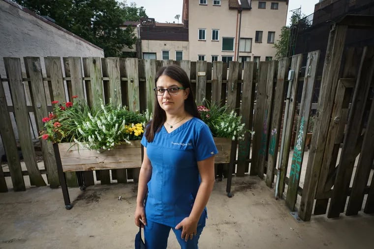 Cassandra Gafford in the backyard of her home in Philadelphia. She worried going back to work as a dentist in a pandemic would put her whole family in danger.