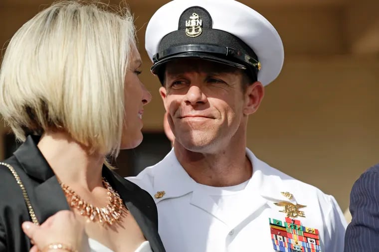 FILE - In this July 2, 2019 file photo, Navy Special Operations Chief Edward Gallagher, right, walks with his wife, Andrea Gallagher as they leave a military court on Naval Base San Diego, in San Diego. The Navy has dismissed charges against an officer for allegedly not reporting war crimes by Gallagher, who was later acquitted of murder. A Navy official with knowledge of the decision not authorized to speak publicly confirmed said charges against Lt. Jacob Portier were dropped Thursday, Aug. 1, 2019.
