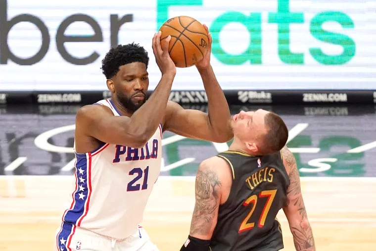 Joel Embiid (left) clipping Chicago's Daniel Theis on the chin Monday night. Embiid finished with just 13 points, far below his season average.