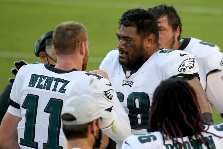 In his first NFL start, Jordan Mailata (right) did a good job of protecting quarterback Carson Wentz.