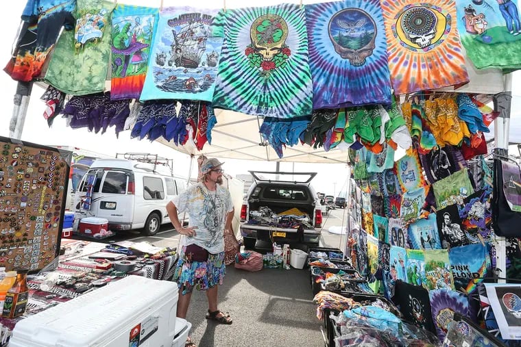 "Shakedown Street" vendor Richard Kumpfer, 32 from Northern Florida with his tie-dye shirts in the Phish parking lot before the concert. Tuesday, August 7 , 2018 STEVEN M. FALK / Staff Photographer