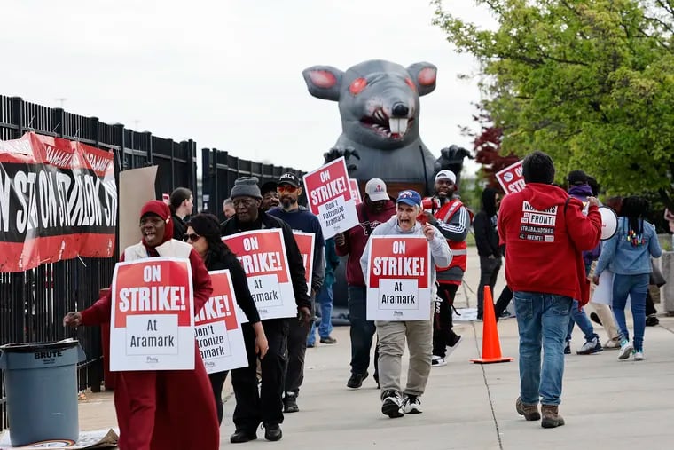 Members of Unite Here, who are employed by Aramark, picket near the Wells Fargo Center before the Sixers and Knicks playoff game on Thurs., April 25, 2024.