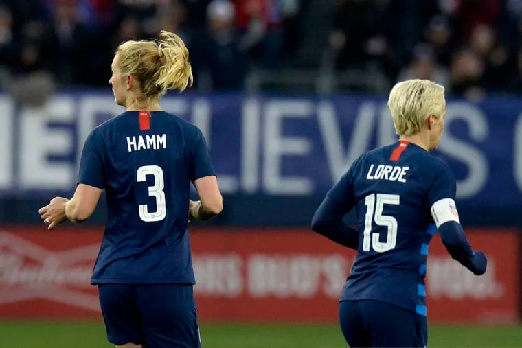 United States midfielder Samantha Mewis (3) and forward Megan Rapinoe (15) play against England during the second half of a SheBelieves Cup women's soccer match Saturday, March 2, 2019, in Nashville, Tenn. Mewis honors Mia Hamm and Rapine honors Audre Lorde by wearing their names on the back of their jerseys.