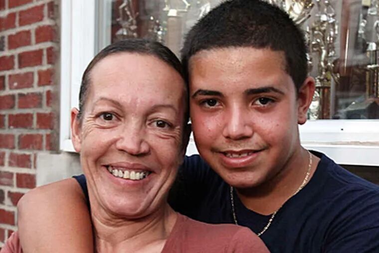 Matthew Marrero with his mom, Maria Laboy, who inspired the teen to share his good fortune. (Steven M. Falk/Staff)