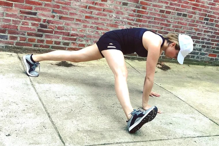 Ashley Greenblatt demonstrates a push-up heel tap exercise.