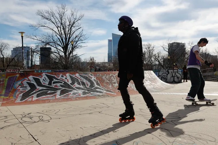 A rollerblader and a skateboarder ride in Paine's Park during a vigil for Tyre Nichols and a community skate demo and protest against police brutality on Feb. 19.