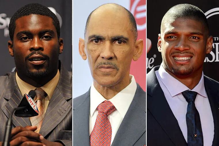 From left to right: Jets quarterback Michael Vick, former NFL head coach Tony Dungy and Rams defensive end Michael Sam.