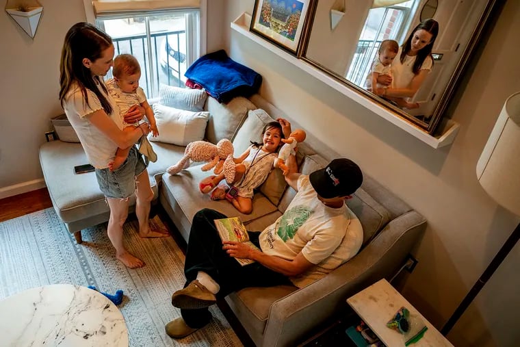 Liz and Matt Lockerman at their home in the city's Fairmount neighborhood with their son Logan, now 1, and Sophie, 4. Last month, RSV, a cold-like respiratory virus, landed Logan in Children's Hospital of Philadelphia for four days. The hospital was crammed with kids with RSV.