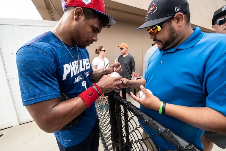 Nick Williams signs an autograph during a workout at Phillies spring training.