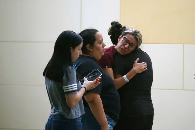 People react to the school rampage outside of the Civic Center in Uvalde, Texas on Tuesday.