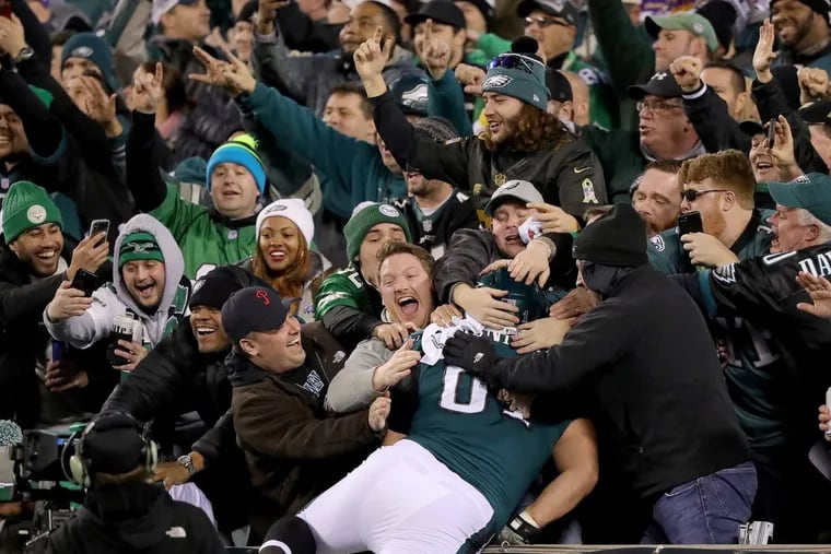 Eaglesâ€™ fans celebrate as Stefen Wisniewski, jumps into the stands after Alshon Jeffery scores in the 4th quarter against the Vikings. Philadelphia Eagles win 38-7 over the Minnesota Vikings in the NFC Championship game in Philadelphia, PA on January 21, 2018. They will face the Patriots in the Super Bowl. DAVID MAIALETTI / Staff Photographer