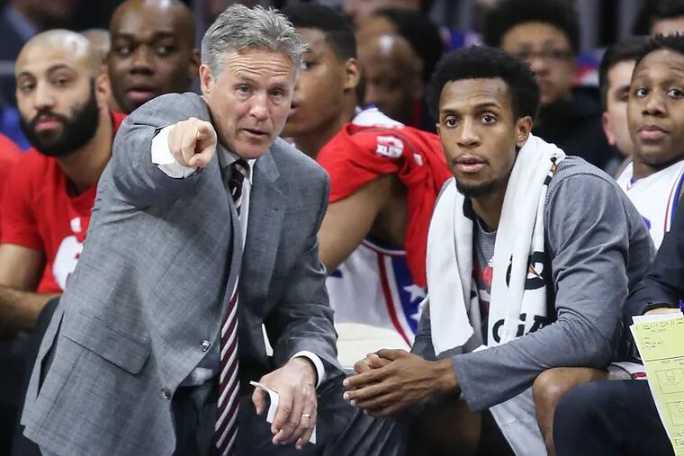 Sixers' head coach Brett Brown talks with Ish Smith during a foul shot against the Suns during the 4th quarter at the Wells Fargo Center in Philadelphia, Tuesday,  January 27, 2016. Sixers beat the Suns 113-103.