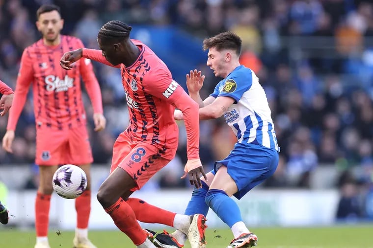 Billy Gilmour of Brighton fouls Amadou Onana of Everton resulting in a red card during the Premier League match between Brighton & Hove Albion and Everton FC at American Express Community Stadium on February 24, 2024 in Brighton, England.
