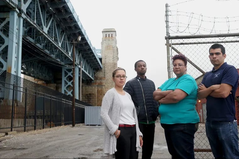 From left, North Camden residents Felisha Reyes Morton, Rudy M. Underdue, Jackie Santiago and Luis Gaitan stand for a portrait outside the F.W. Winter building in Camden. They oppose the proposed erection of a 16-story digital billboard on the site by Interstate Outdoor Advertising.
