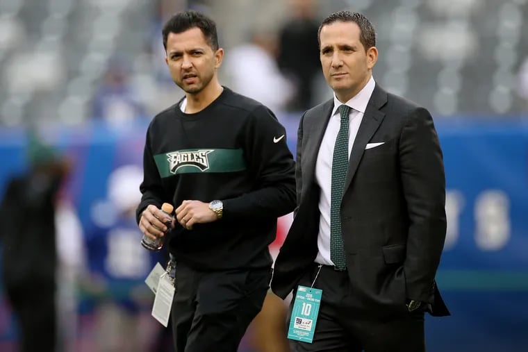 Eagles chief medical officer Arsh Dhanota, left, talks with general manager Howie Roseman before a game against the New York Giants at MetLife Stadium in East Rutherford, N.J., on Sunday, Dec. 29, 2019. Nearly a year later, the Eagles remain one of the most injured teams in the NFL.