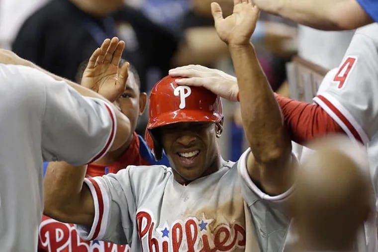 Ben Revere (2) celebrates in the dugout after scoring the winning run during the 10th inning of a baseball game in Miami, Friday, April 12, 2013, against the Miami Marlins. The Phillies won 3-1 in 10th innings. (J Pat Carter/AP)