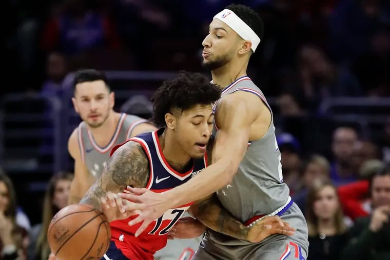 Ben Simmons tries to steal the ball from the Wizards' Kelly Oubre during their Friday game.