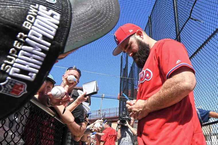 The Eagles&#039; Jason Kelce signs autographs during his visit to Phillies spring training on Monday.