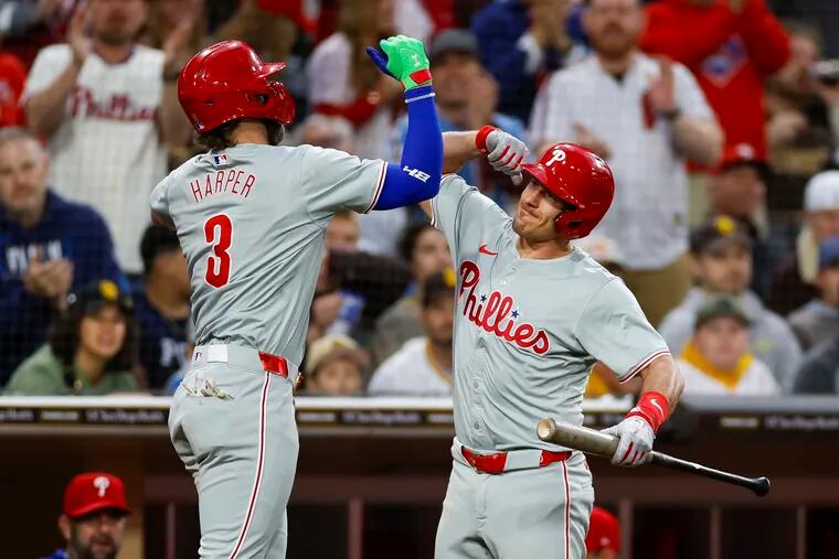 Bryce Harper (left) and J.T. Realmuto (right) each hit home runs in the Phillies win over the Padres on Friday night.