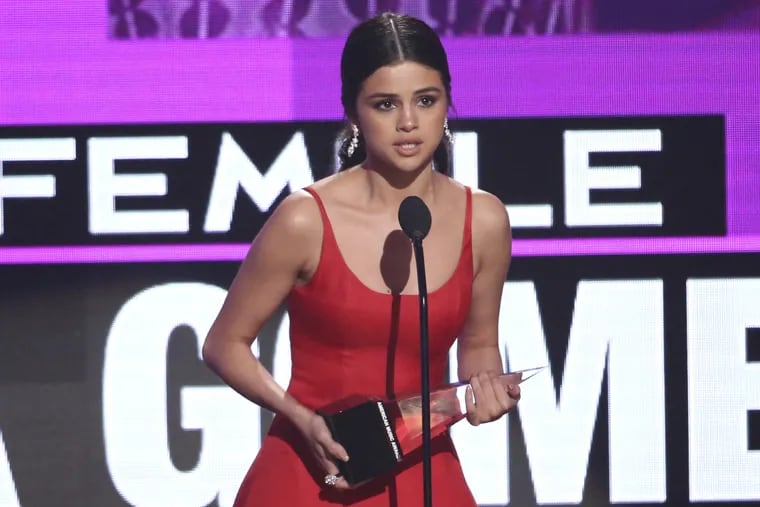 Selena Gomez accepts the award for favorite female artist pop/rock at the American Music Awards at the Microsoft Theater.