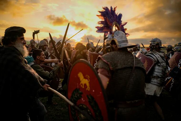Men re-enact a battle between Roman legions and members of a Romanian village last year . (AP Photo/Andreea Alexandru)