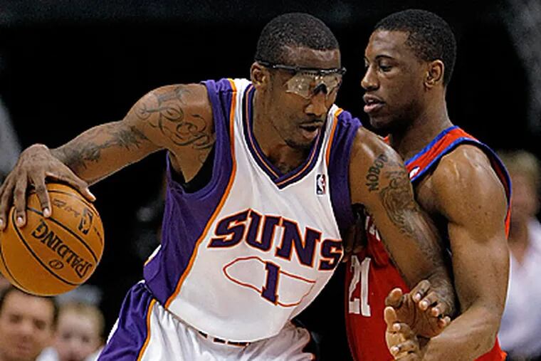 Phoenix Suns' Amare Stoudemire backs down Thaddeus Young during the second quarter. (AP Photo/Matt York)