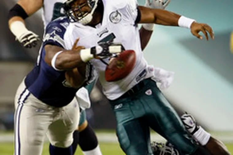 Donovan McNabb is hit by Cowboys defensive end Marcus Spears and fumbles on game&#0039;s first play.