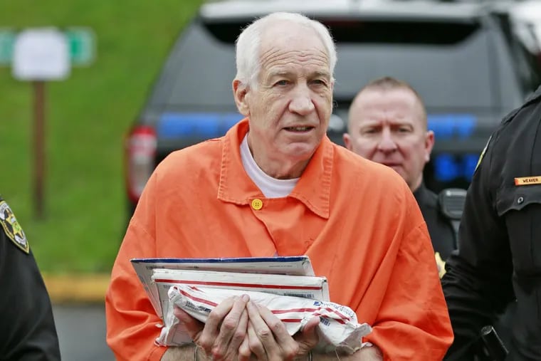 Former Penn State assistant football coach Jerry Sandusky is escorted into the Centre County Courthouse in Bellefonte, Pa., on May 2, 2016.